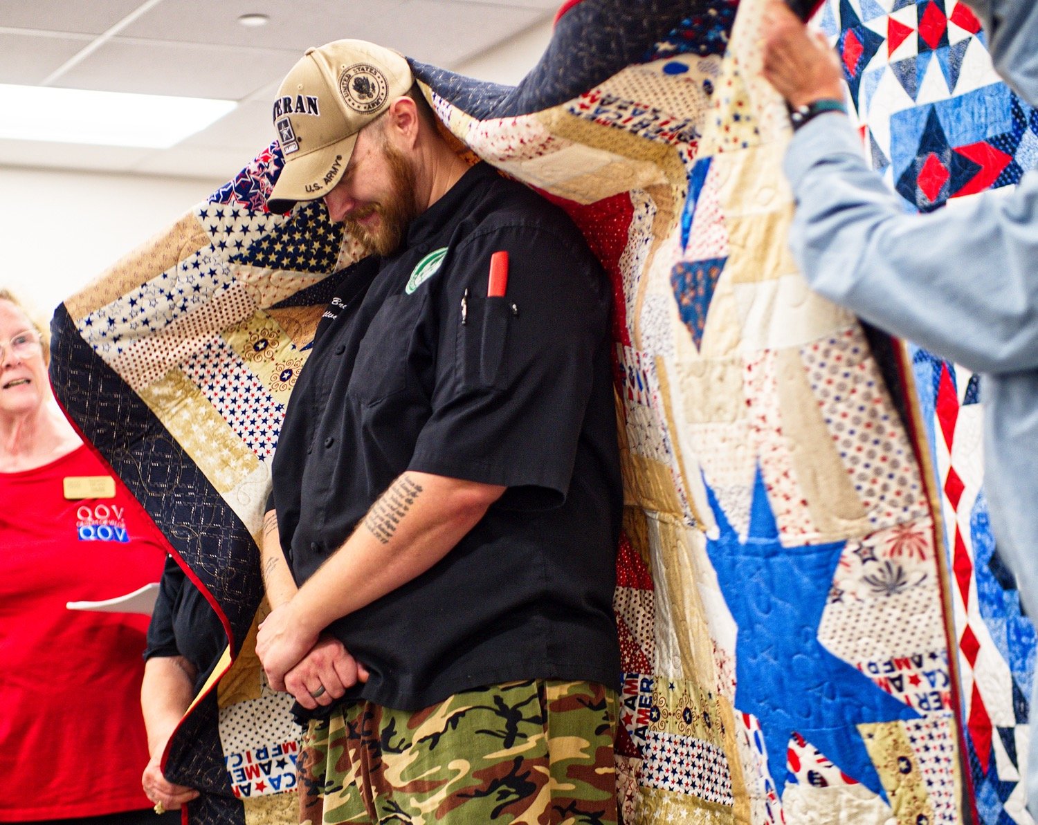 Army veteran Tyler Brown was the first to be wrapped in a quilt made especially for him, as he was also preparing the meal for after the ceremony. He later said, "My mom’s a quilter so I know what goes into these things and it’s appreciated." [view more veteran appreciation]